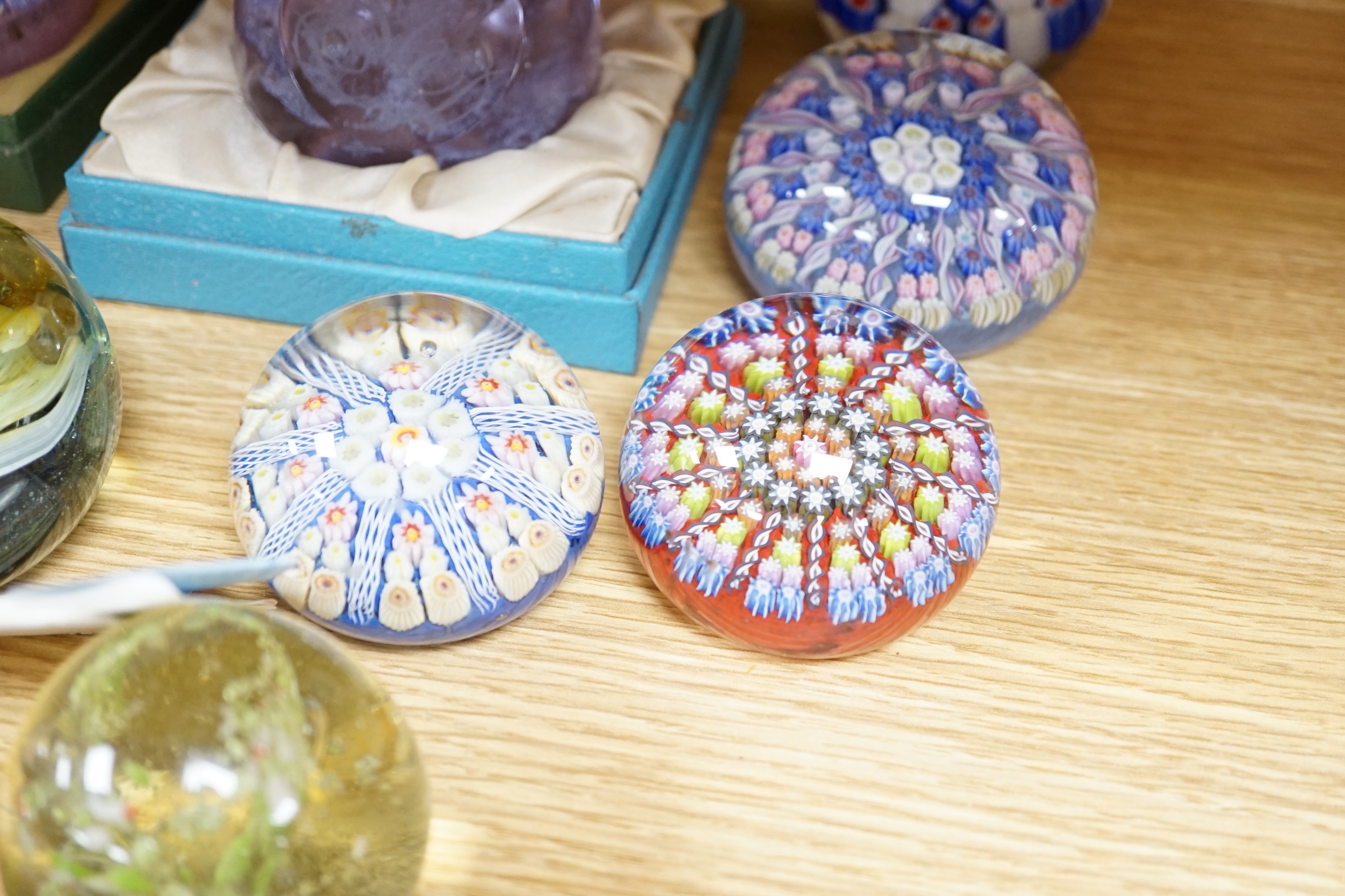 A collection of coloured glass paperweights including Strathearn, Caithness (28)